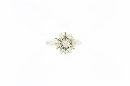 White gold ring in the shape of a flower, set with