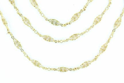 Yellow gold long necklace with a swirl-patterned c