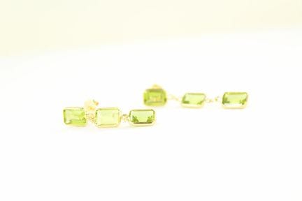 A pair of yellow gold earrings, each likely set wi