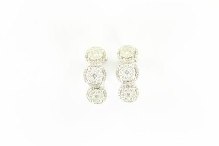 Pair of 18K white gold earrings featuring three mo