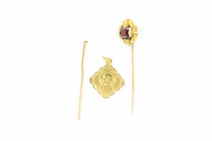Virgin medal (engraved), a bent pin, and a tie pin
