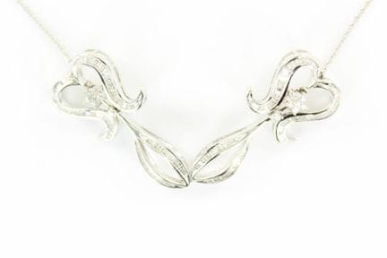 18K white gold necklace featuring a central scroll