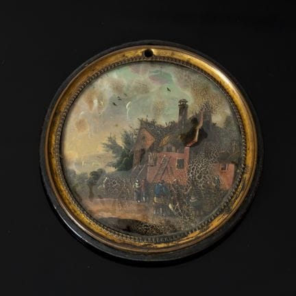 A medallion with a small painting under glass depi