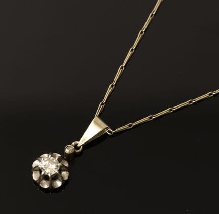 A 750‰ white gold chain and pendant, set with a di