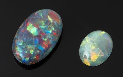 Two opals on paper, cut into cabochons. Height: 15