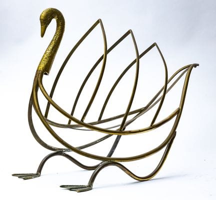 A brass magazine rack shaped like a swan. Made in 