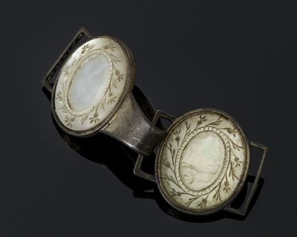 A cape clasp made of 800‰ silver and engraved moth