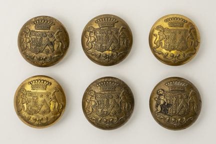A set of six buttons bearing the coats of arms of 