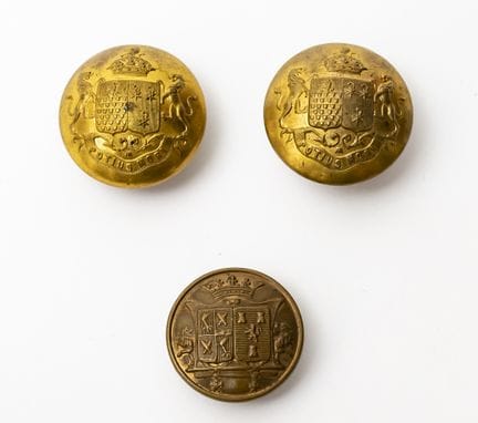 Two livery buttons bearing the combined coat of ar