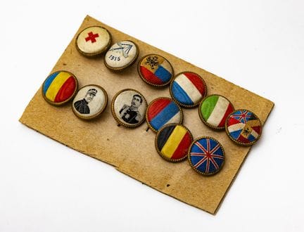 A set of 12 patriotic pin badges depicting the fla