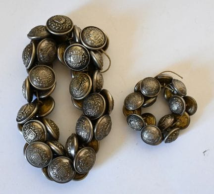 About fifty buttons bearing the coat of arms of th