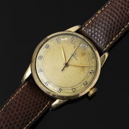 OMEGA. A men's wristwatch with a round gold-plated