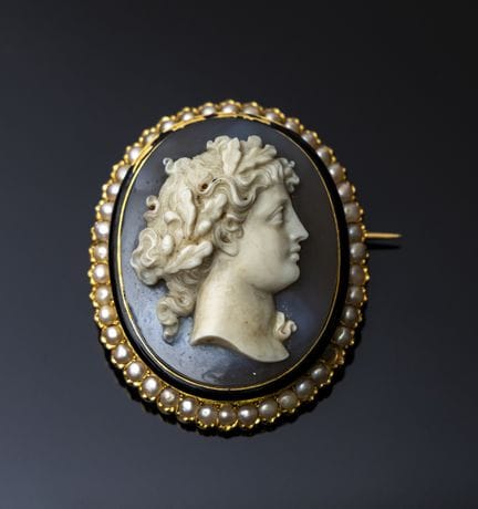 A large 750‰ gold cameo brooch with enamel, set wi
