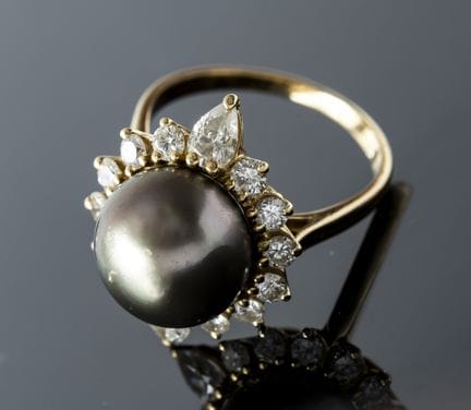 A 750% yellow gold ring set with a gray pearl—know