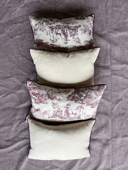 A bedspread made of heathered mauve herringbone ca