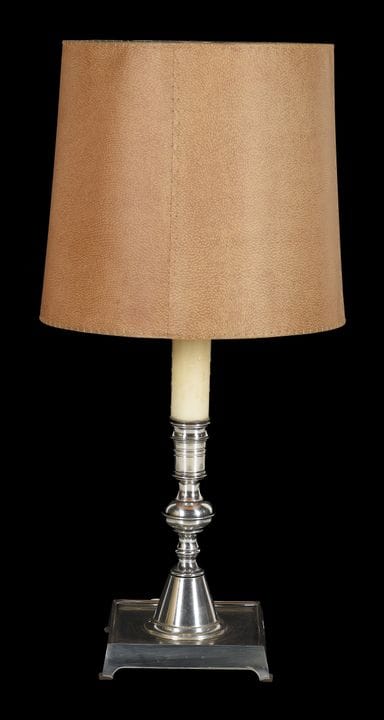 Table lamp made of silver plated metal with a leat