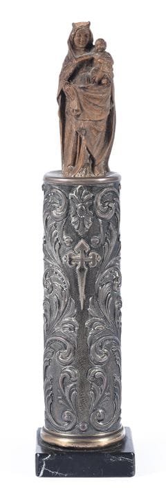 A figure carved from wood and silver depicting the