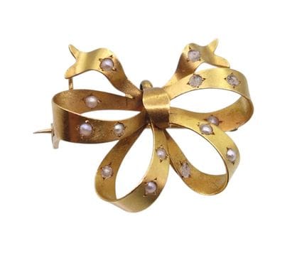 Broche de oro con forma de lazo engastado con perl