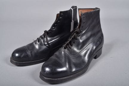 All—A pair of black leather officer's shoes with e