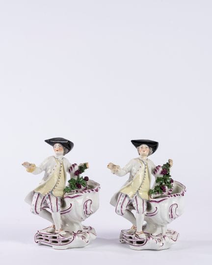 A pair of polychrome porcelain salt cellars in the