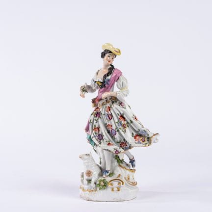 Polychrome porcelain group depicting a shepherdess