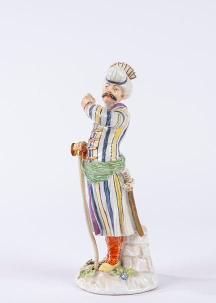 Polychrome porcelain statuette depicting a Persian