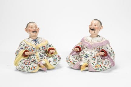 Two polychrome porcelain Magot figurines with head