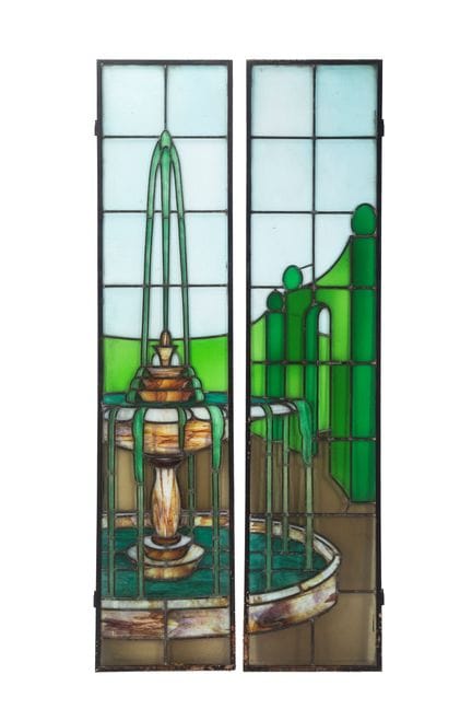 A pair of stained-glass windows depicting a founta