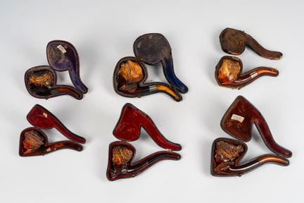 Six carved meerschaum pipes depicting a gentleman 