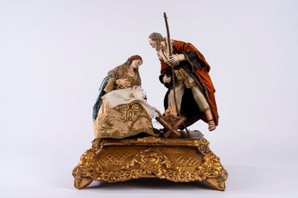 Nativity scene sculpture group within a display ca