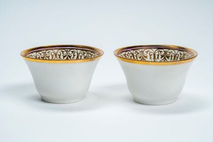 A pair of porcelain cups with gold rims. France, m