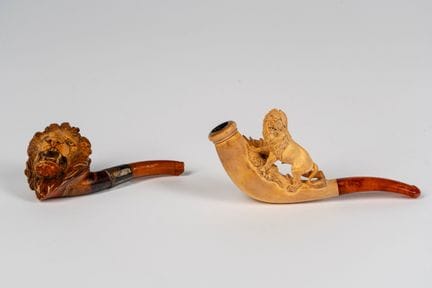 Two meerschaum pipes carved in the shape of a lion