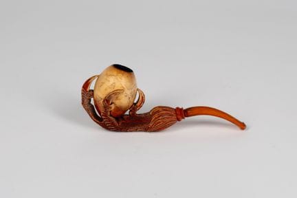 A meerschaum pipe carved in the shape of a claw, h