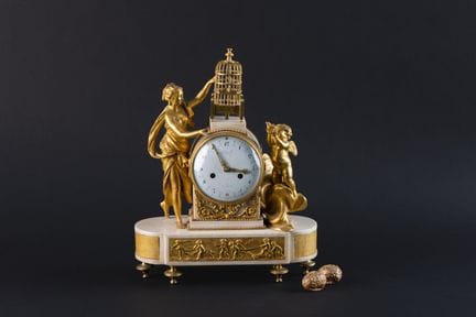 A clock known as a "cage clock" or "bird clock," m