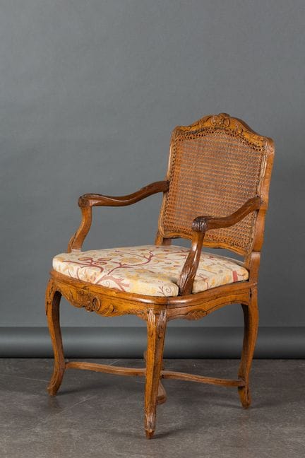 Molded and carved beech armchair, cane-woven back 