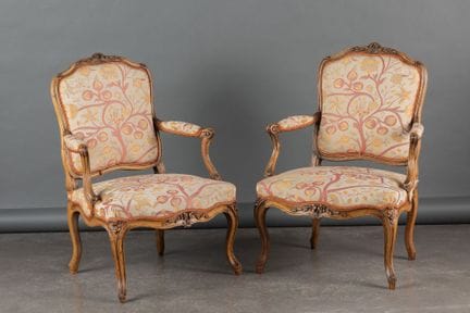 Pair of walnut armchairs with flat backs and curve