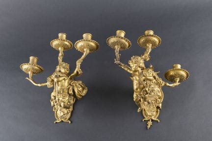 A pair of pendant wall sconces made of chiseled an