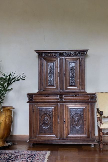 A small two-section sideboard in molded and carved