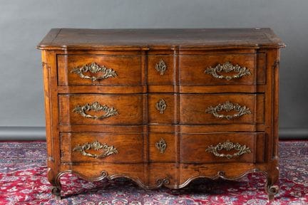 Molded cherry wood chest of drawers. Features thre
