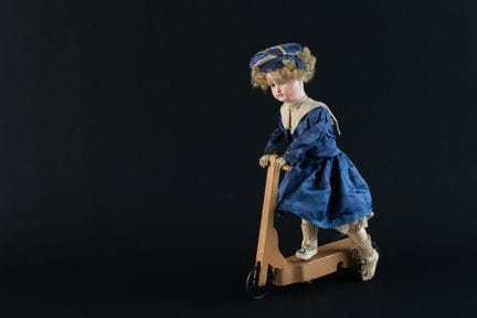 Automatic doll on a wooden scooter, circa 1920
34 