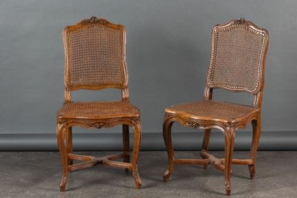 Pair of chairs in molded and carved walnut, with c