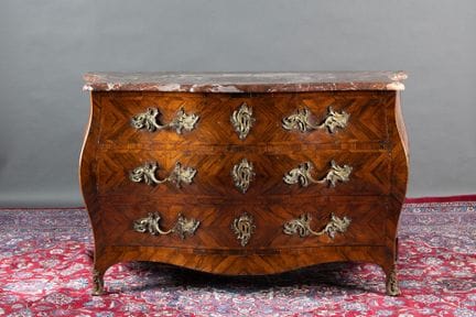 A large chest of drawers made of rosewood marquetr