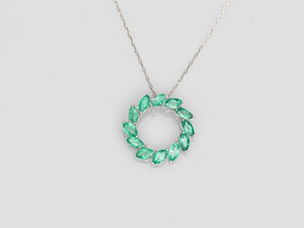 Platinum circle pendant, set with navette-cut emer