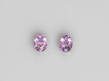 Pair of platinum stud earrings, each set with a fa