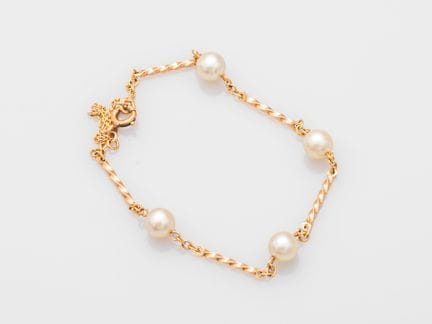 Matching 750°/°° (18K) gold bracelet featuring twi