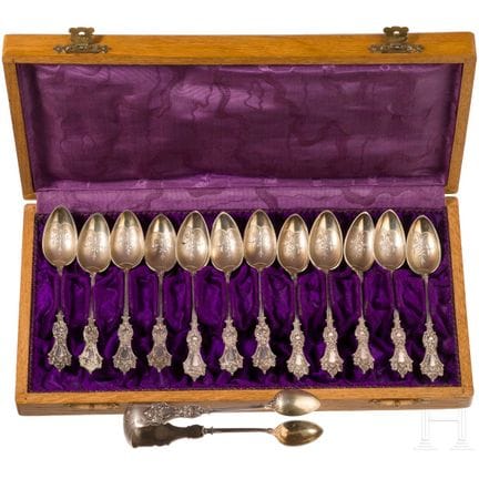 Twelve silver partial-gilt tea spoons and a sugar 
