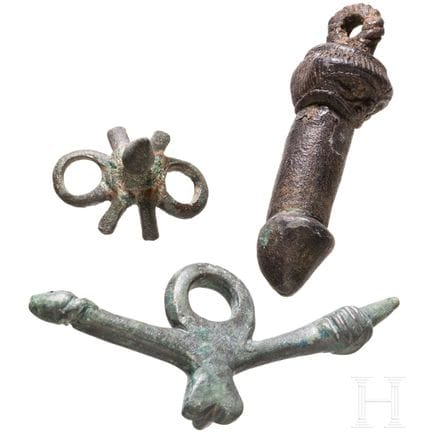 Two bronze phallic amulets and a spur, Roman, 2nd–