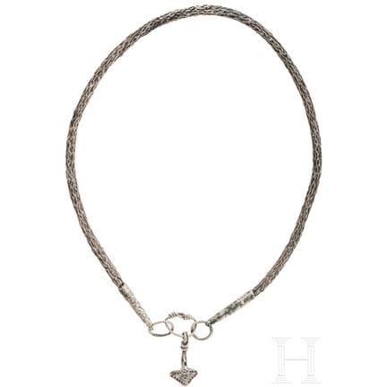 An ornate Thor’s hammer on a solid silver foxtail 