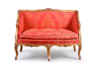 Small carved wooden sofa, molded and gilded on all