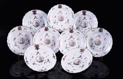 迈森九件套瓷盘，盘缘呈弧形，采用卡基蒙风格的多色彩绘，中央饰有小景，描绘了宝塔与灌木，周围环绕着花卉